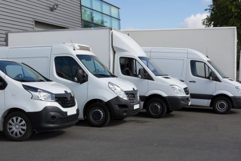 White Delivery Trucks parked in Warehouse Building